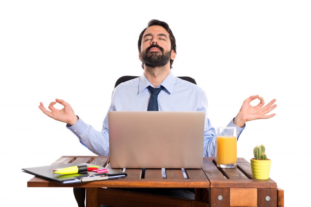 Businessman in his office in zen position